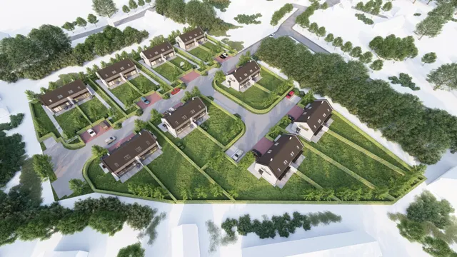 Šikmý letecký pohled na obytný soubor dvojdomů se sedlovými střechami, zahradami a vnitřní komunikací